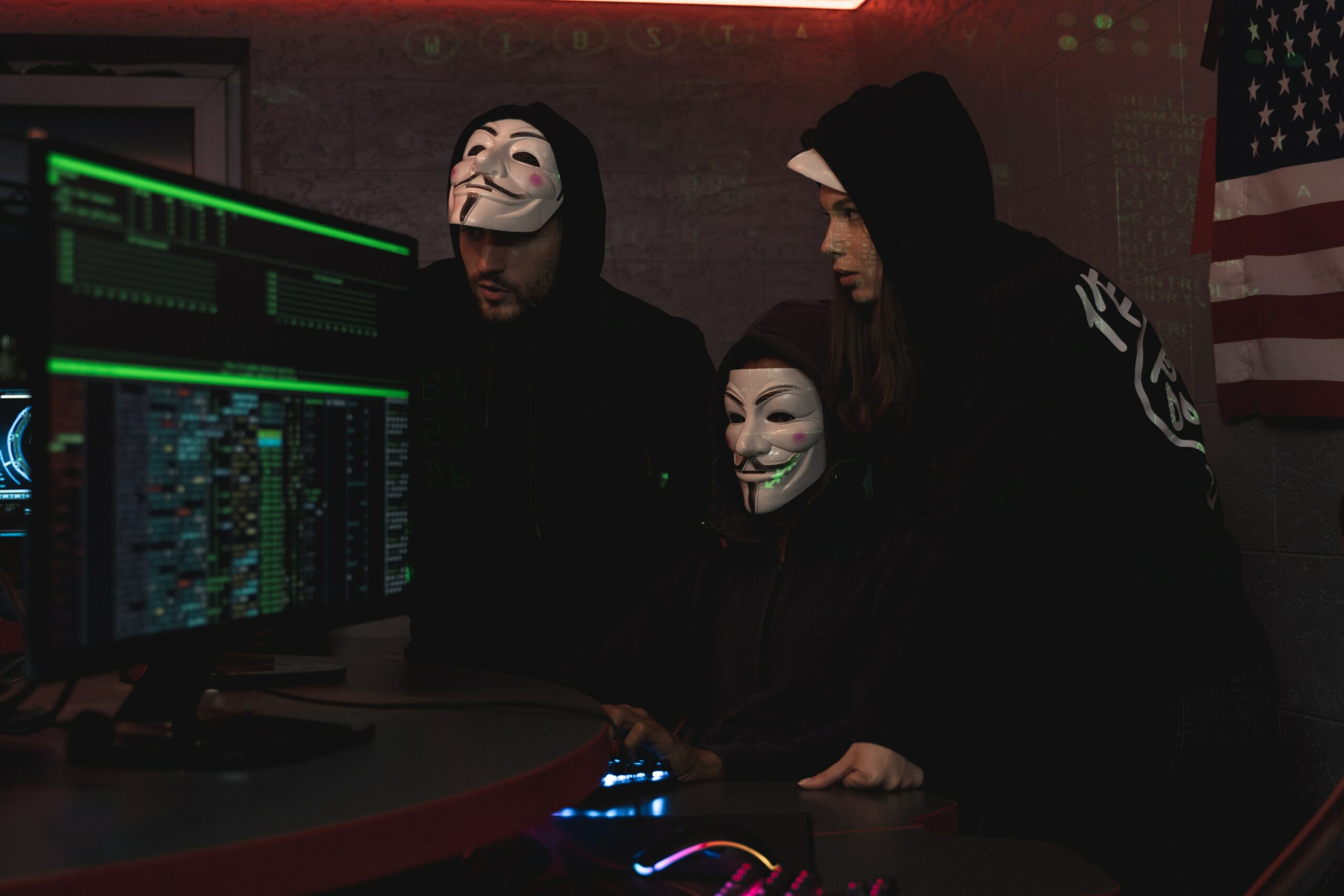 Masked people looking at monitors